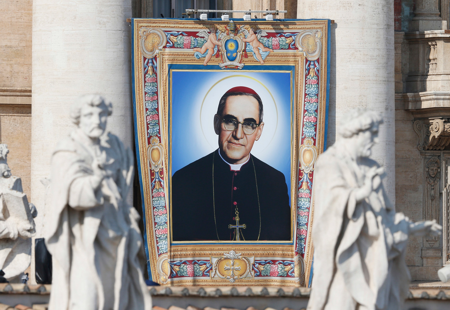 A banner of new St. Oscar Romero hangs from the facade of St. Peter’s Basilica as Pope Francis celebrates the canonization Mass for seven new saints in St. Peter’s Square at the Vatican Oct. 14.